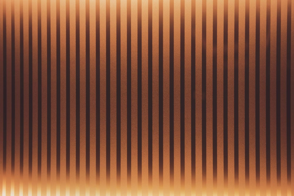 Americana interior design with warm amber lighting, stripe wall panels, and natural textures for an inviting home.